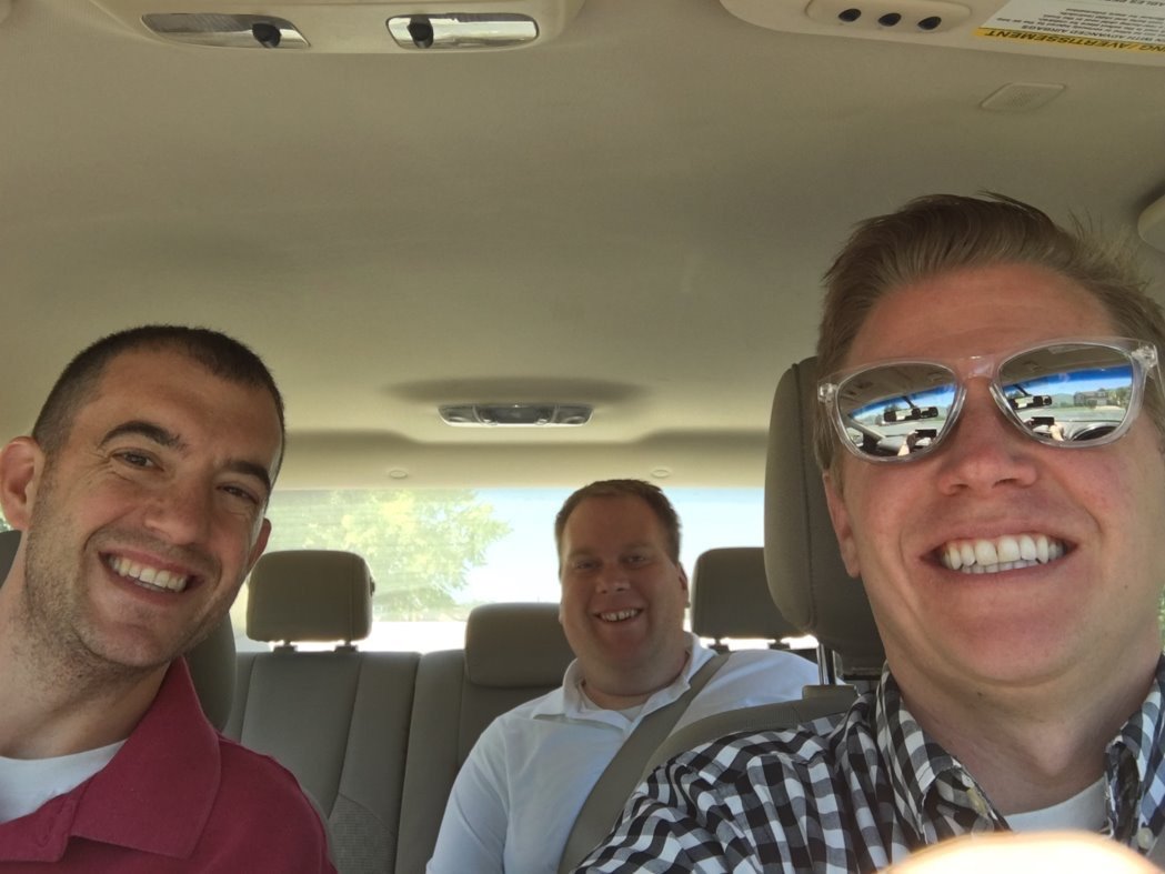 Selfie of 3 men in a car: Jeremy, his product partner, and a sales rep on the way to a customer visit.